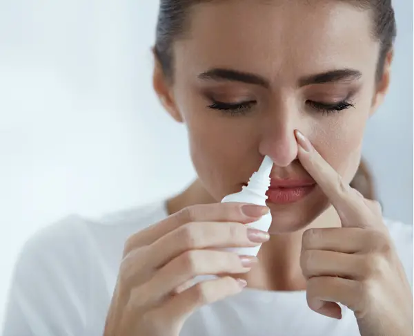 woman using nasal spray