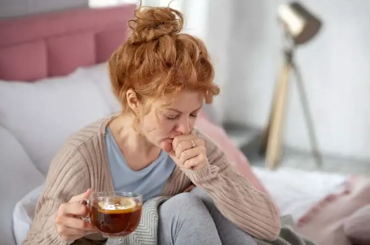 woman-coughing-and-drinking-mullein-tea